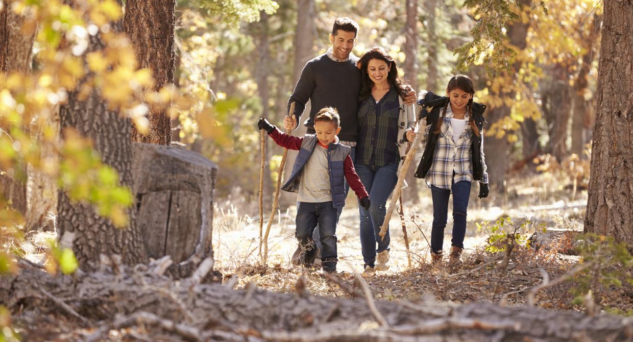 A family enjoys a fall hike. Photo credit: Adobe Stock