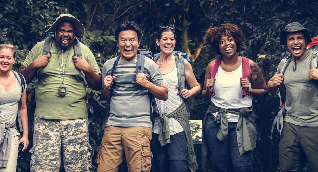 A group photo of hikers smiling. Photo by Adobe Stock.